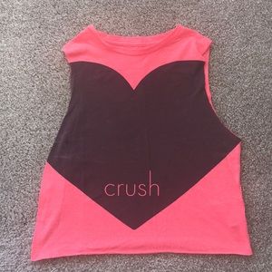 A pink crop top shirt that says “crush”